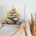 Framed canvas print of Zen rocks stacked with yellow flowers in watercolour