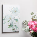 Framed canvas print of abstract white flowers with impasto technique and gentle dripping elements