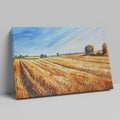 Framed canvas print of golden wheat fields under a blue sky in a rural landscape