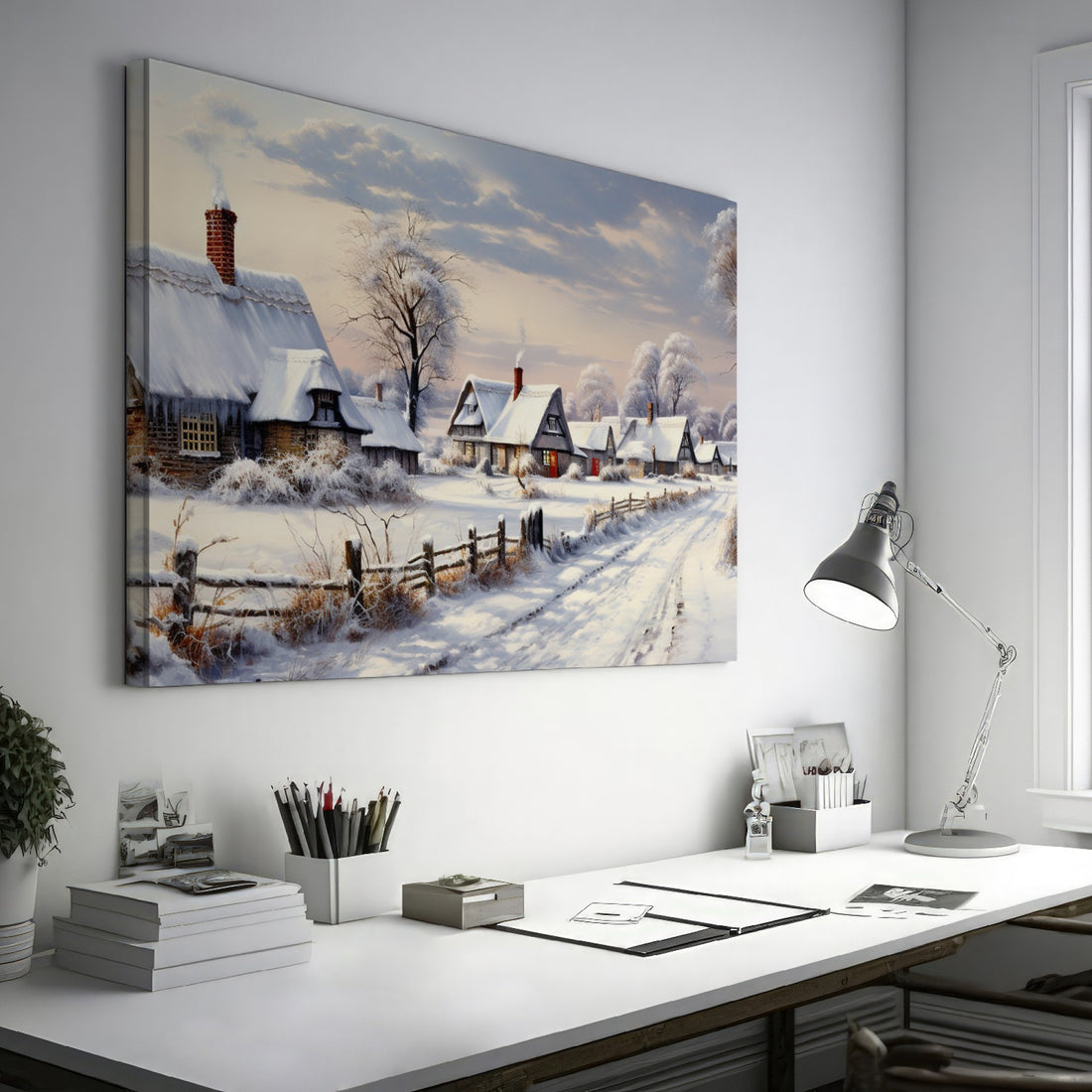 Framed canvas print of a winter scene with snow-covered thatched cottages and a country lane