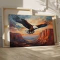 Framed canvas print of a majestic eagle soaring over a canyon at sunset