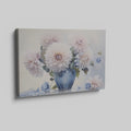 Framed canvas print of realistic dahlia flowers in a vintage blue vase with soft pastel tones