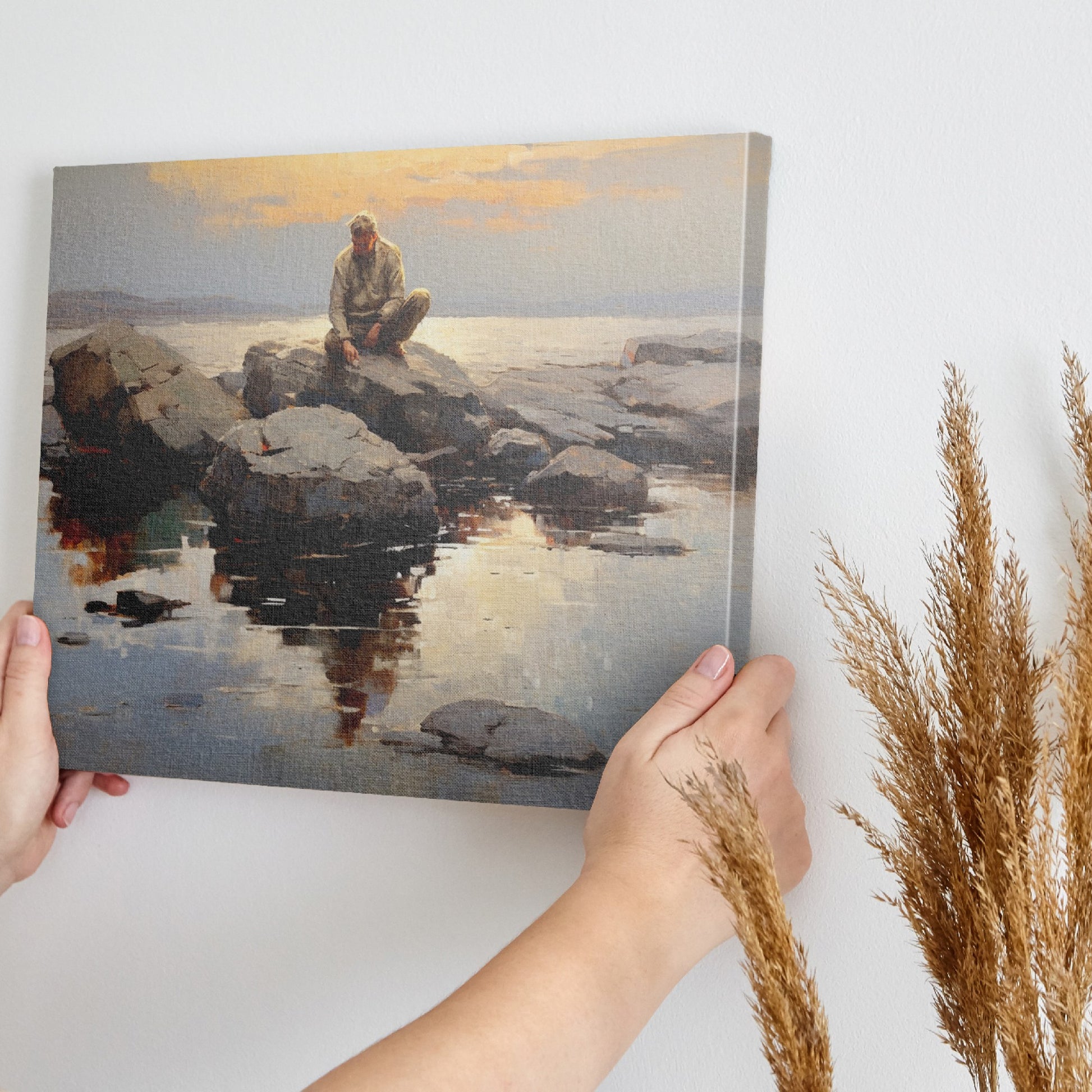 Framed canvas print of serene seascape with man sitting on rocks at sunset