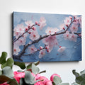 Framed canvas print of cherry blossoms with rain droplets on blue background