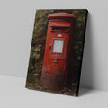 Framed canvas print of a classic British red postbox surrounded by greenery