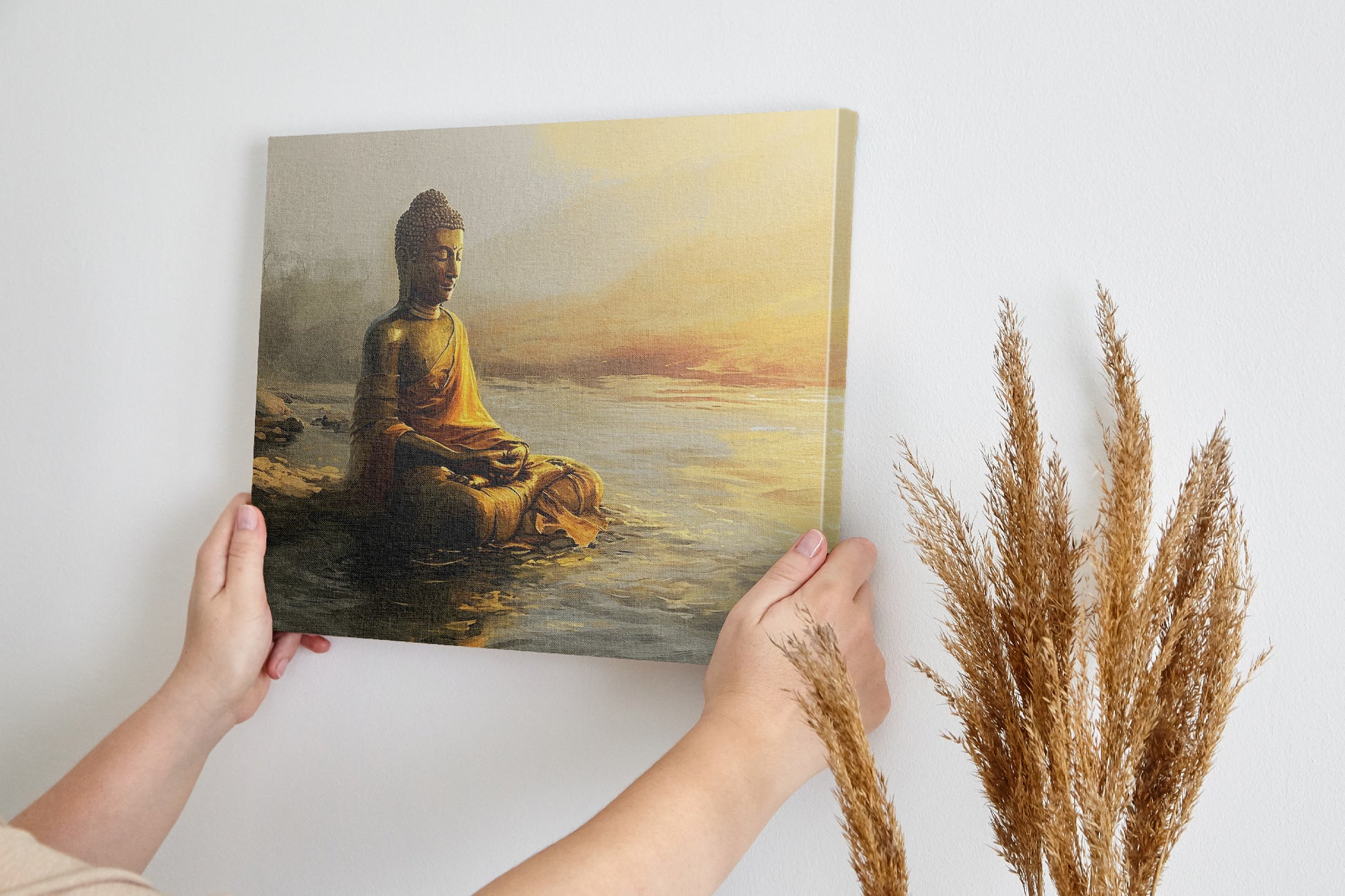 Wall canvas print of a meditative Buddha statue in golden and orange hues reflecting on tranquil waters at sunrise.