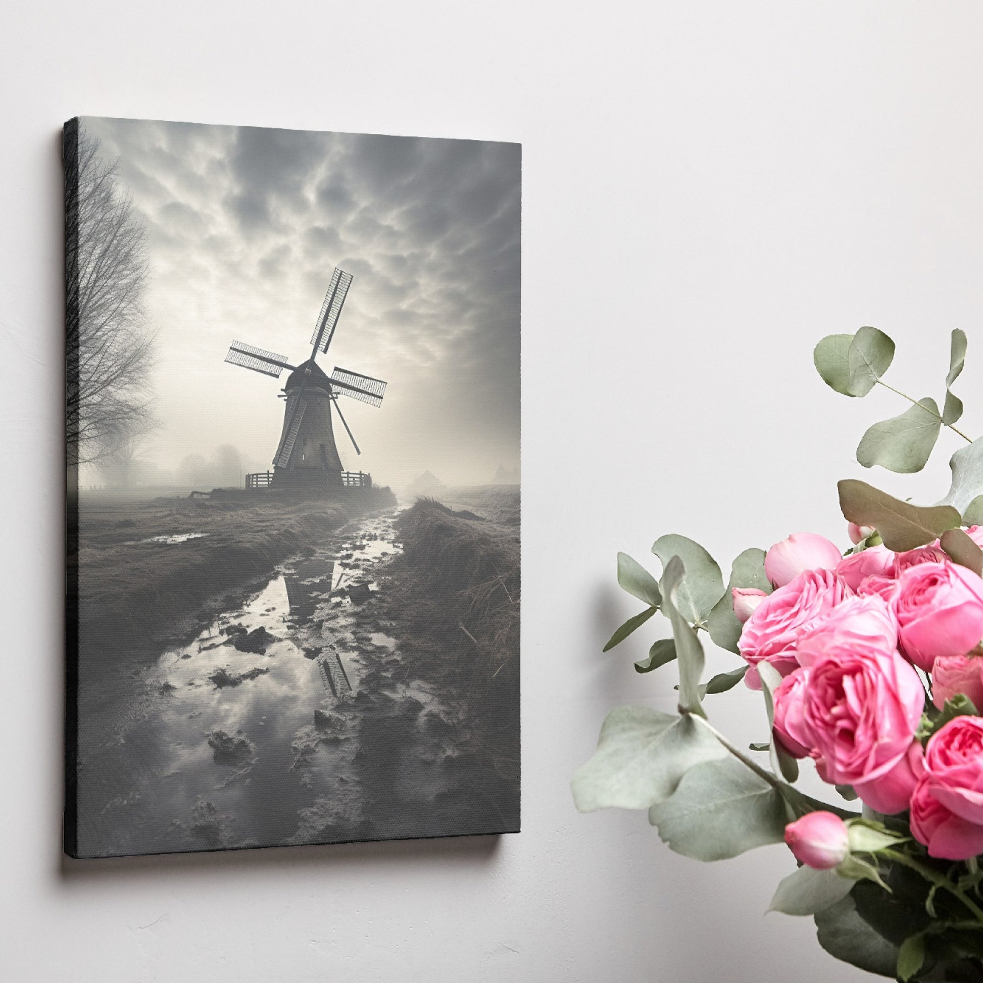 Framed canvas print of a misty Dutch windmill landscape with dramatic sky and reflection in puddle