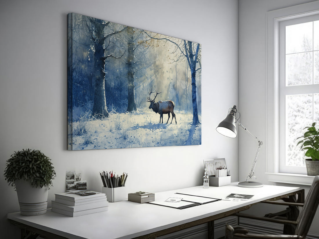 Framed canvas print of a stag in a snow-covered forest with a watercolour blue and white palette