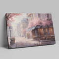 Framed canvas print of a Parisian cafe on a cobblestone street with cherry blossoms in full bloom