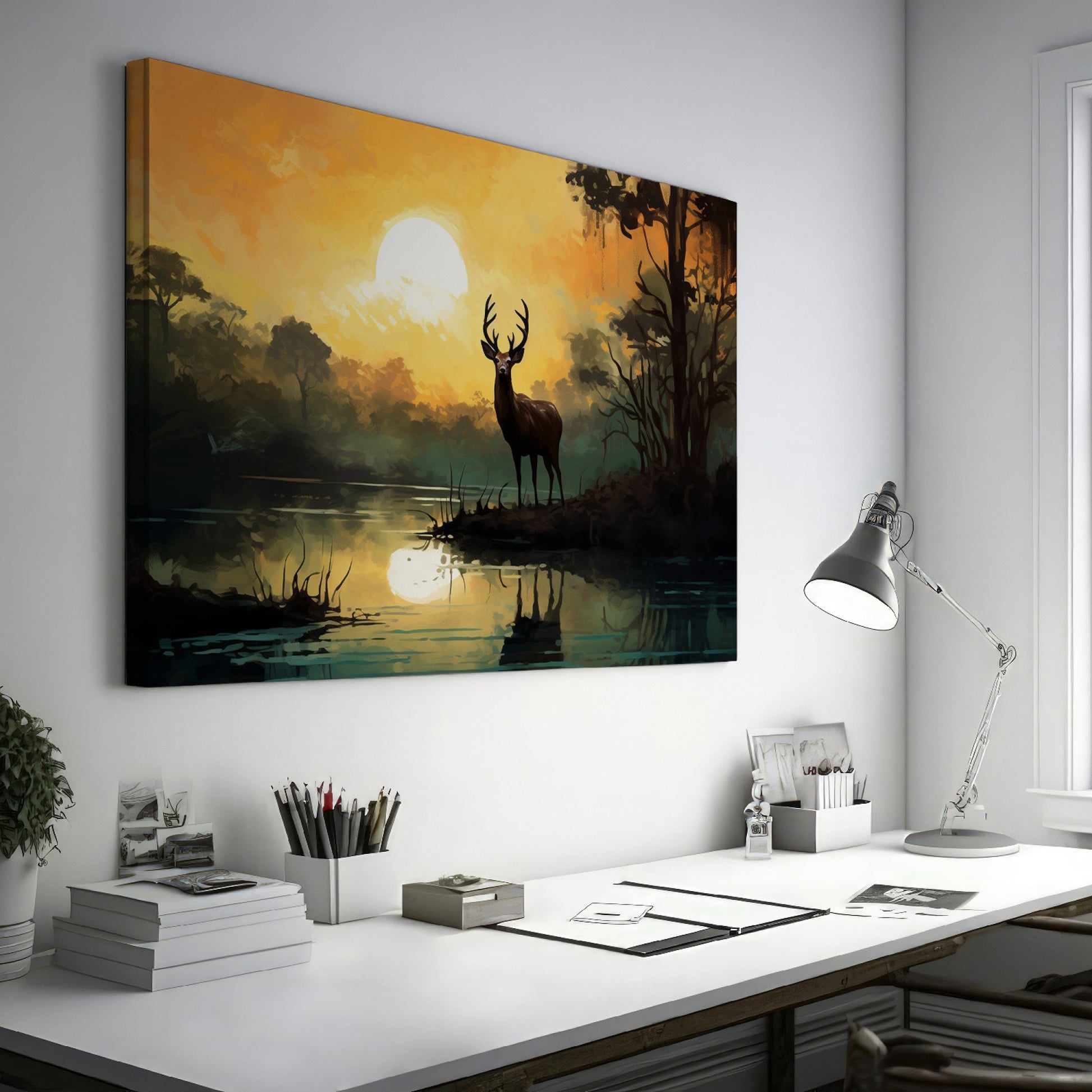 Framed canvas print of a majestic stag against a forest lake at sunrise with orange skies