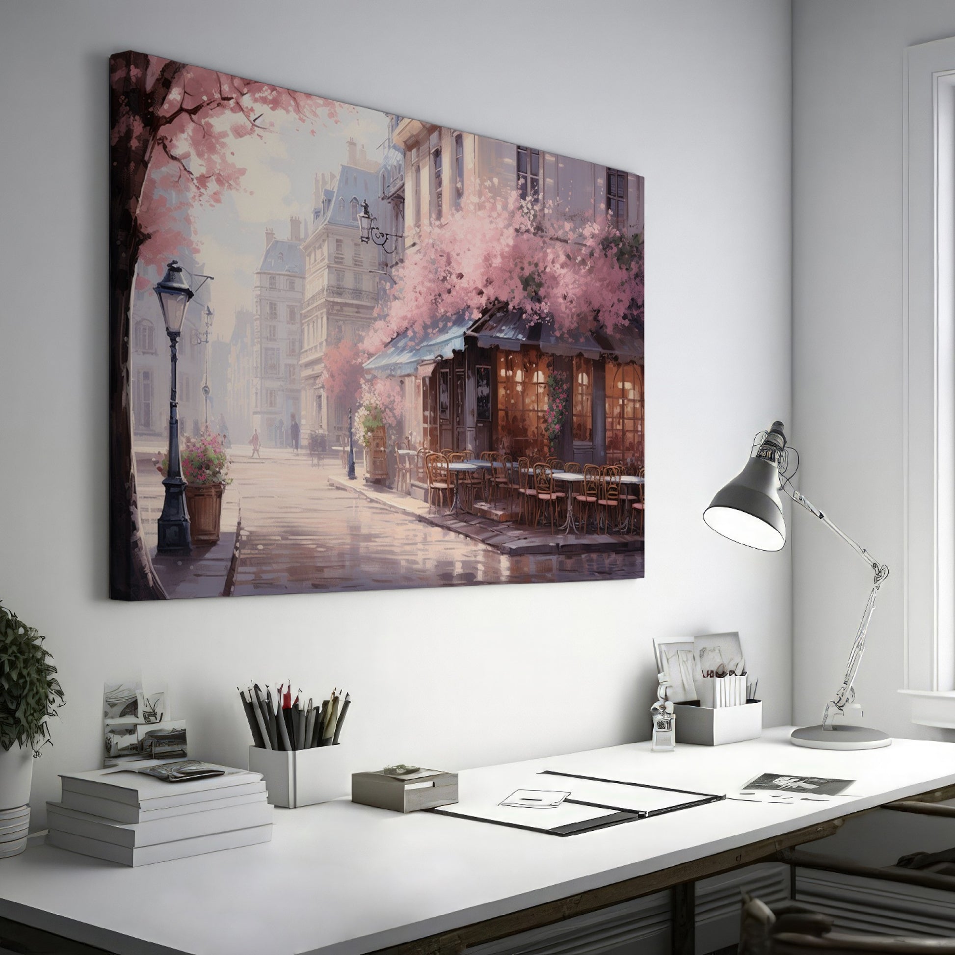 Framed canvas print of a Parisian cafe on a cobblestone street with cherry blossoms in full bloom