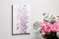 Framed canvas print of delicate lilac blossoms with pastel purple petals and green leaves