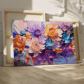 Framed canvas print of vibrant impasto-style abstract flowers in orange, lavender, and blue