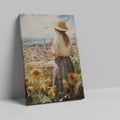 Framed canvas print of a woman gazing over a sunflower field and vintage town