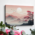 Framed canvas print of a tranquil pink sunrise over mountains with a reflective lake and silhouette of a tree