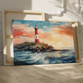 Framed canvas print of a vibrant sunset seascape with a red and white lighthouse on a cliff