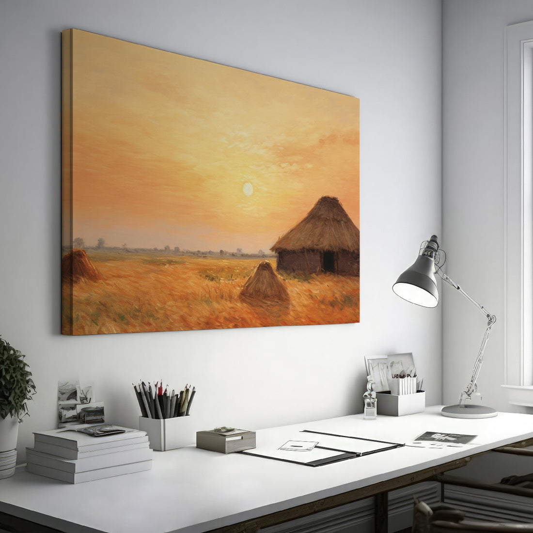 Framed canvas print of a rustic thatched cottage in a countryside landscape at sunset with warm golden and orange hues