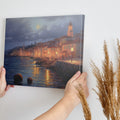 Framed canvas print of a moonlit Mediterranean coastal town with glowing street lamps