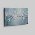 Framed canvas print of serene cherry blossoms with impasto texture on blue background