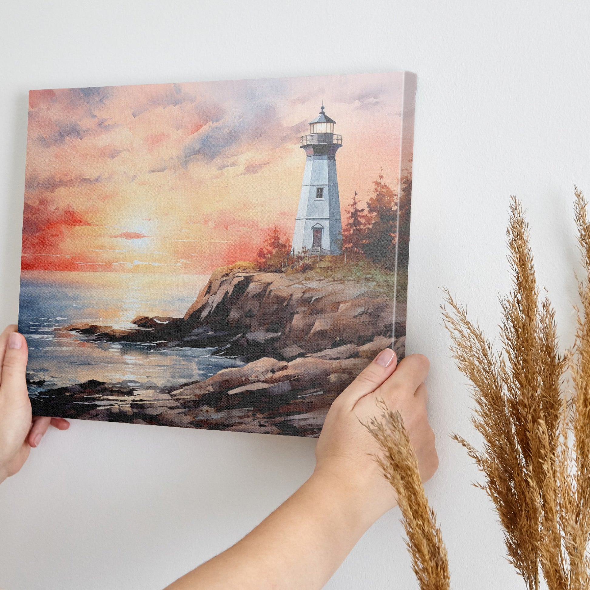 Framed canvas print of a watercolour lighthouse seascape at sunset with vibrant hues of pink, blue, and gold