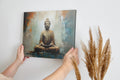 Framed canvas print of a meditative Buddha statue with abstract background in warm and neutral tones