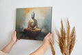 Framed canvas print of serene Buddha in meditation with abstract warm background