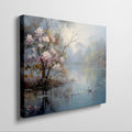 Framed canvas print of impressionist painting with blossoming trees by a serene lake