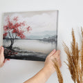 Framed canvas print of a serene landscape painting showcasing a vibrant red tree against a monochrome backdrop with flying birds