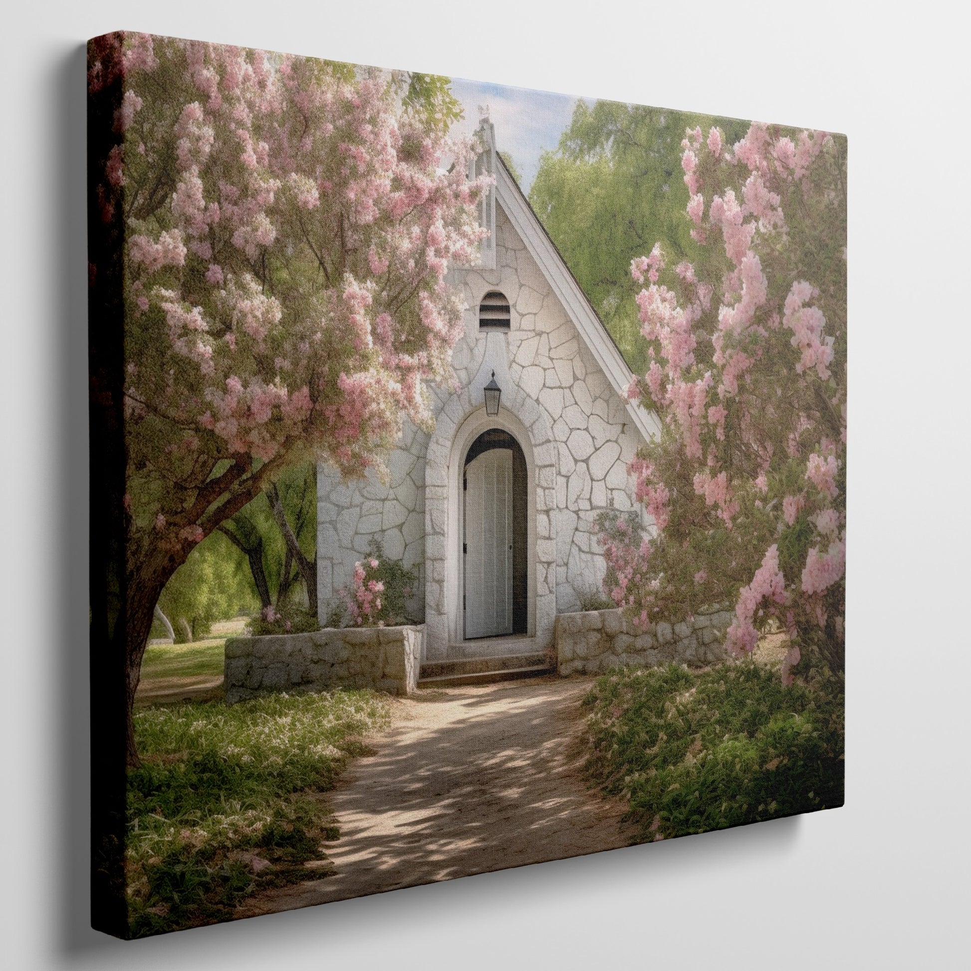 Framed canvas print of a chapel surrounded by lush pink blossom trees