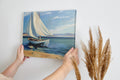 Framed canvas print of a serene sailboat seascape with vivid blue ocean and sky