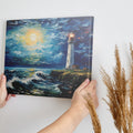 Framed canvas print of an impressionist lighthouse seascape with textured brushwork and dynamic ocean waves