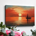 Framed canvas print of a sailboat silhouetted against a sunset with warm red and orange tones