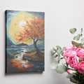 Framed canvas print of an autumnal tree with orange and red leaves against a sunset over a blue seascape