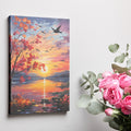 Framed canvas print of an impressionist-style autumn sunset by a lake with birds in flight and vibrant foliage.