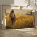 Framed canvas print of a man walking through a golden wheat field during sunset with a rustic feel