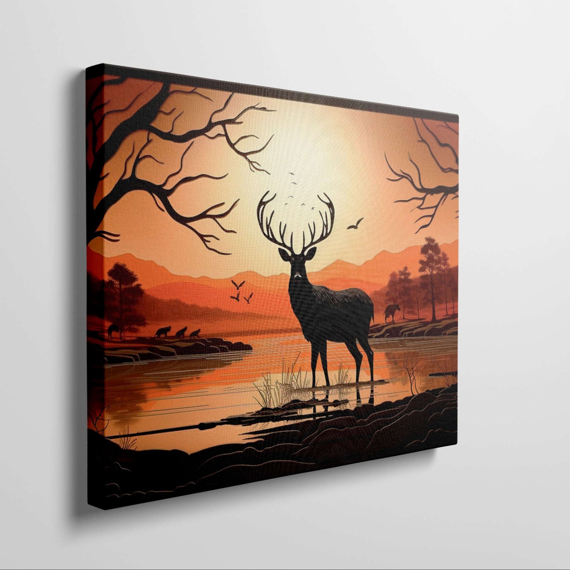 Printed canvas art of a black deer silhouette against an orange sunset with trees and mountains