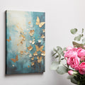 Framed canvas print of abstract painting with butterflies and flowers in gold on a teal background