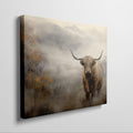 Framed canvas print of a Highland cow in a misty autumnal landscape with warm earthy tones