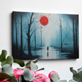 Framed canvas print of a mysterious blue forest with a vibrant red moon and a lone silhouette reflected on the water