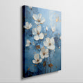 Framed canvas print of contemporary white and gold flowers on a blue background