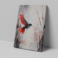 Framed canvas print of a stylised bird with vibrant red wings against a monochrome watercolor background