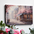 Framed canvas print of a Parisian cafe on a cobblestone street with cherry blossoms in full bloom