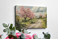 Framed canvas print of a picturesque countryside with cherry blossoms and a farmhouse