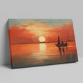 Framed canvas print of a sailboat silhouetted against a sunset with warm red and orange tones