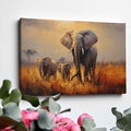 Framed canvas print of a family of elephants in a vibrant, golden savannah sunset