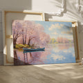 Framed canvas print of a serene river scene with cherry blossoms and a small boat