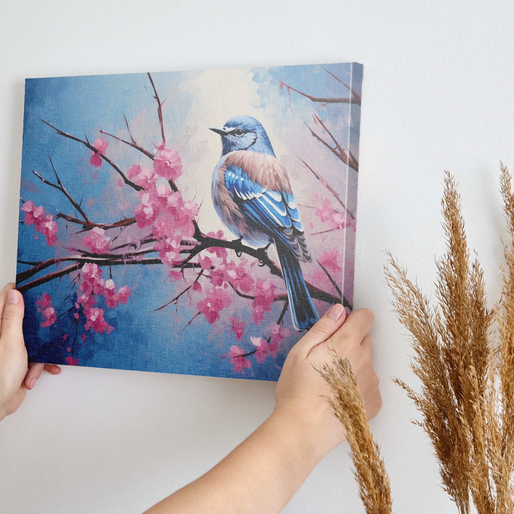 Framed canvas print of a bluebird perched on cherry blossom branches, with vibrant blue and pink hues