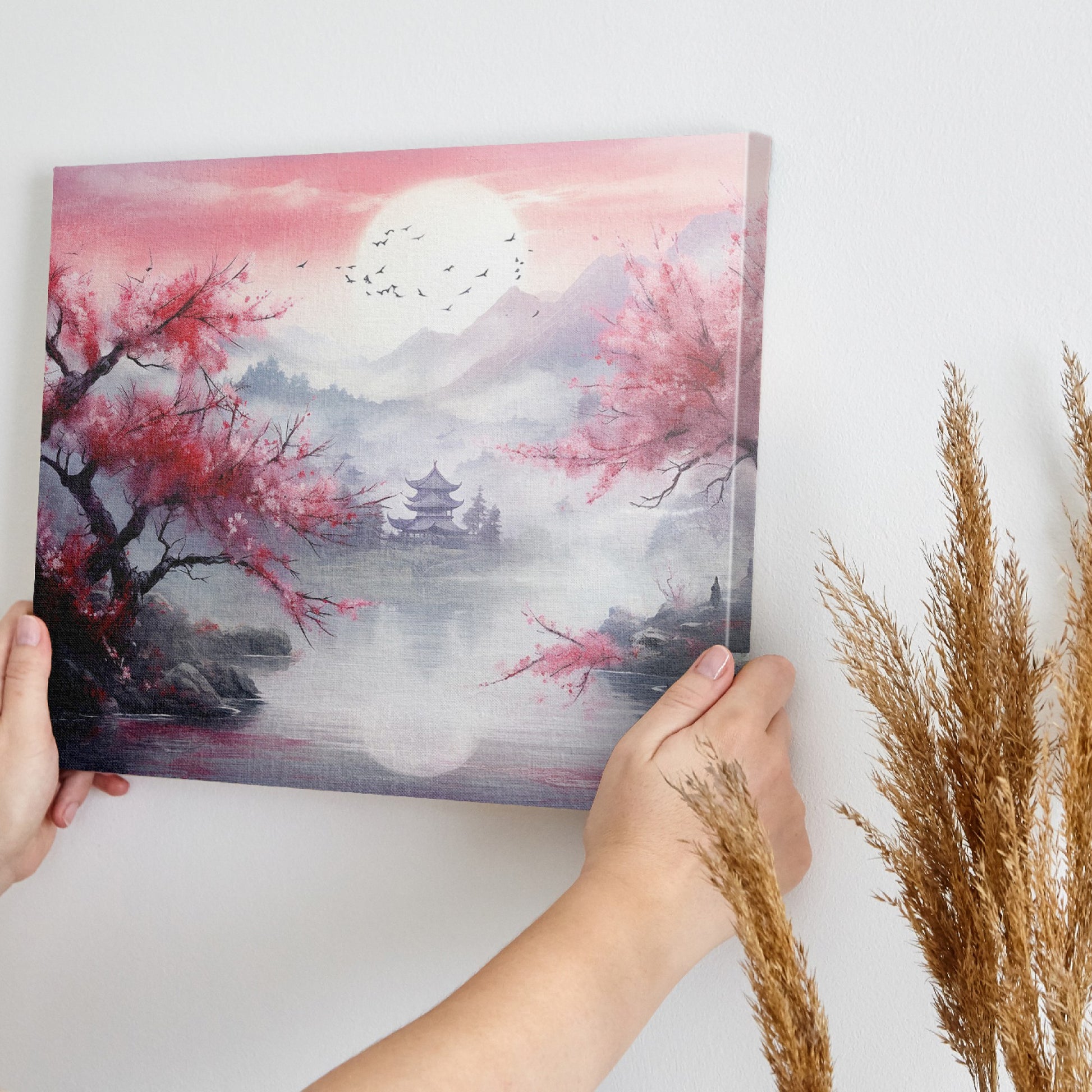 Framed canvas print of an Asian landscape with cherry blossoms and a pagoda at sunset