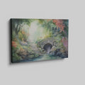 Framed canvas print of a tranquil watercolour garden with a stone bridge and flowing stream surrounded by colourful foliage