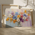 Framed canvas print of vibrant impasto painted flowers in a vase with rich textures and a colourful palette